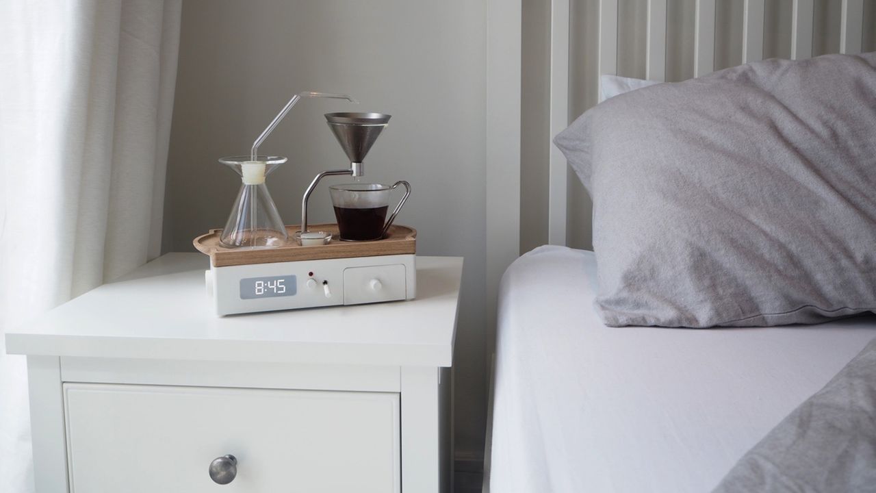 Barisieur tea and coffee maker alarm clock in bedroom on white bedside cabinet