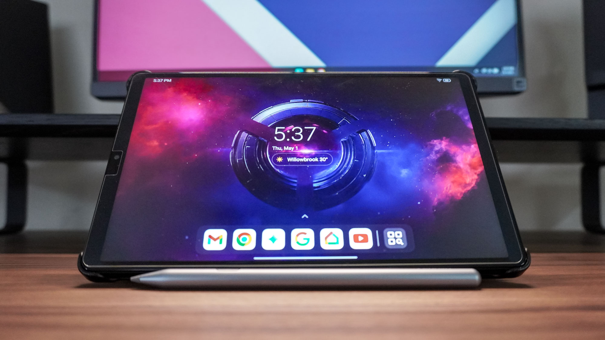 The Lenovo Legion Tab Gen 3 in landscape mode with its optional stylus on a desk