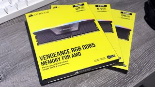 A photograph of three Corsair Vengeance RGB DDR5 memory kits on a desk