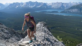 approach shoes vs hiking shoes: hiker on a narrow rocky ridge