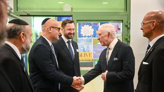 King Charles III with Executive Director of the Jewish Community Centre, Jonathan Ornstein (R), as he meets community members and supporters of the centre during his visit to the Jewish Community Centre (JCC) Krakow