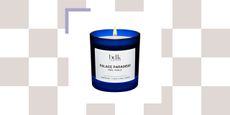 blue candle with a white label