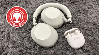 Sony WH-1000XM6 and Bose QC Ultra Earbuds (2nd Gen) laid out on a grey fluffy rug