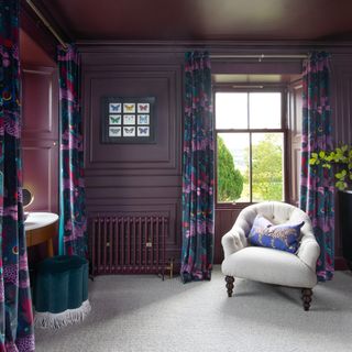 Damson-painted living room with dark, patterned velvet curtains