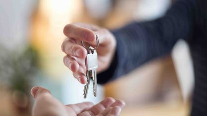 Picture of a hand giving a set of keys to another hand