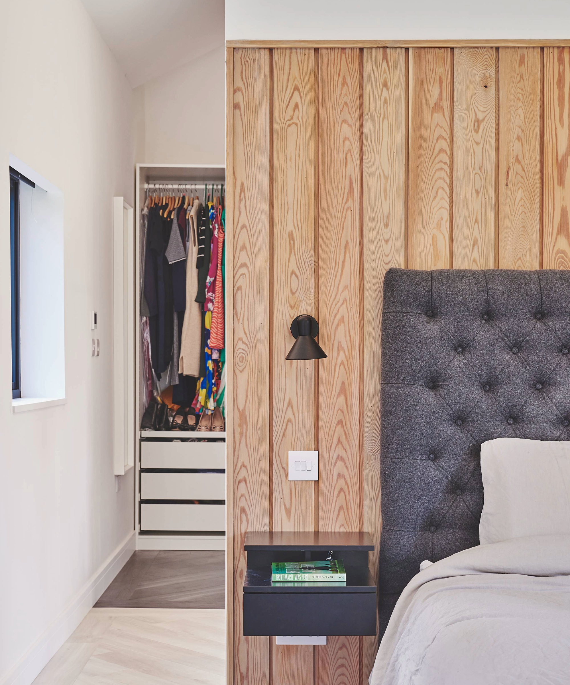 Bedroom with a partition separating the bed from a dressing room