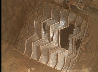 The wheels on NASA's Curiosity Mars rover have accumulated some damage during the robot's nine-plus years on the Red Planet, as this photo snapped by Curiosity's Mars Hand Lens Imager (MAHLI) on Jan. 27, 2022, shows.