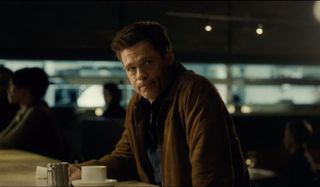 Ad Astra Brad Pitt sitting at a counter with coffee