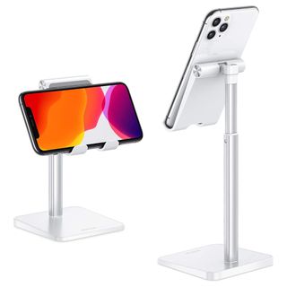 A silver cell phone stand holds a cell phone in place