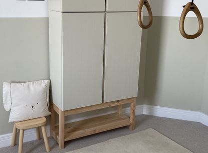 An IKEA IVAR cabinet painted beige on wooden legs