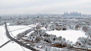 An aerial view across Greenwich Park to the Isle of Dogs after snow fell on December 12, 2022 in London