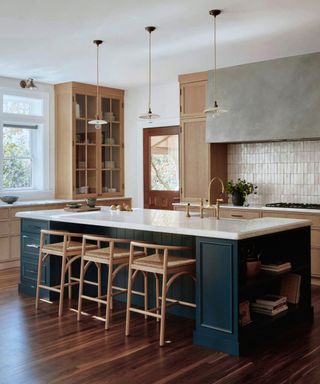 Kitchen with blue island and wood cabinetry around