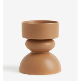 brown candle holder in a curved abstract shape