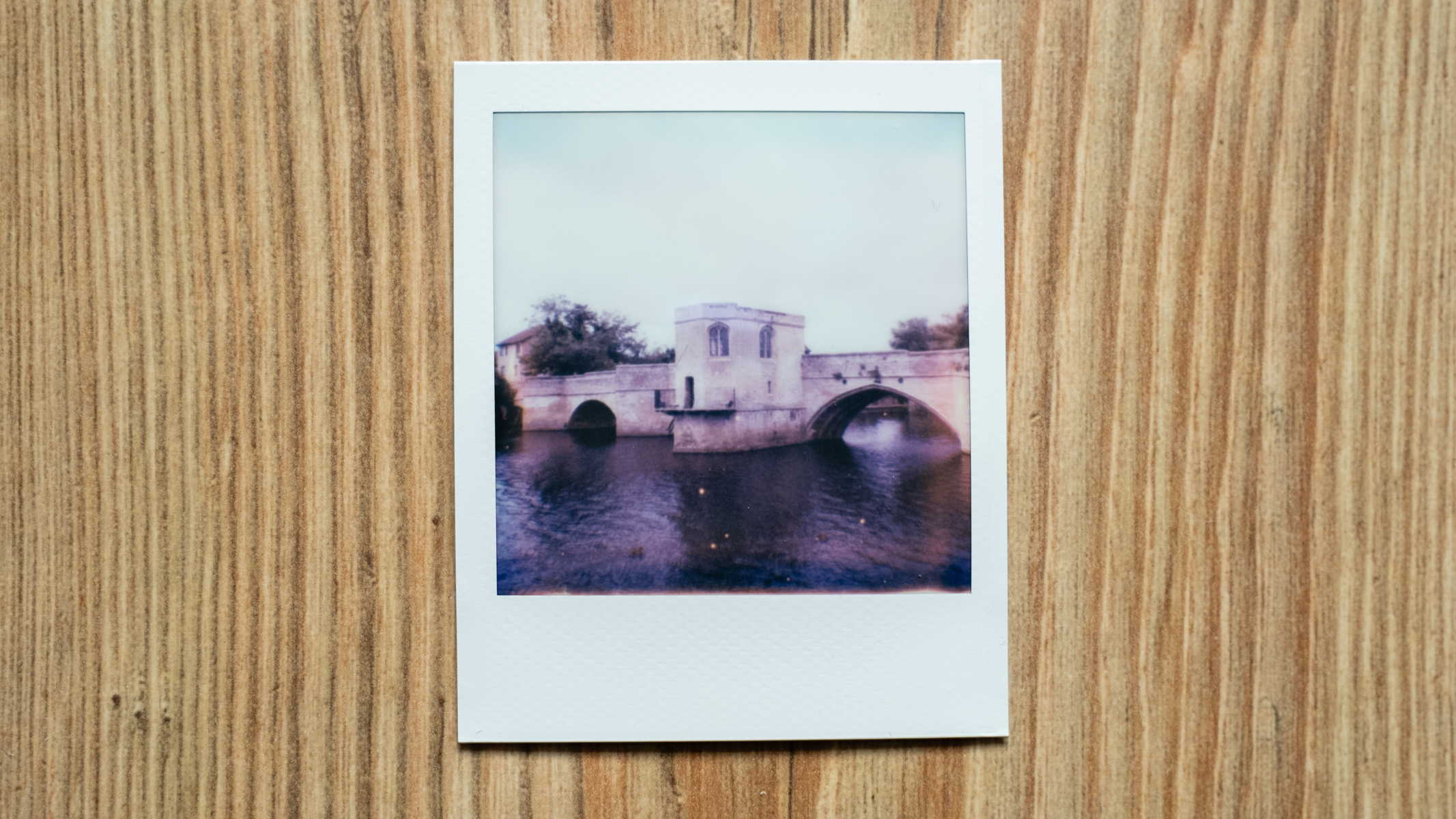 Polaroid Go 2 instant film image of a bridge over a river