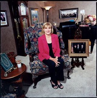 a blonde woman sitting in a chair