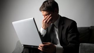 Sad business man and laptop