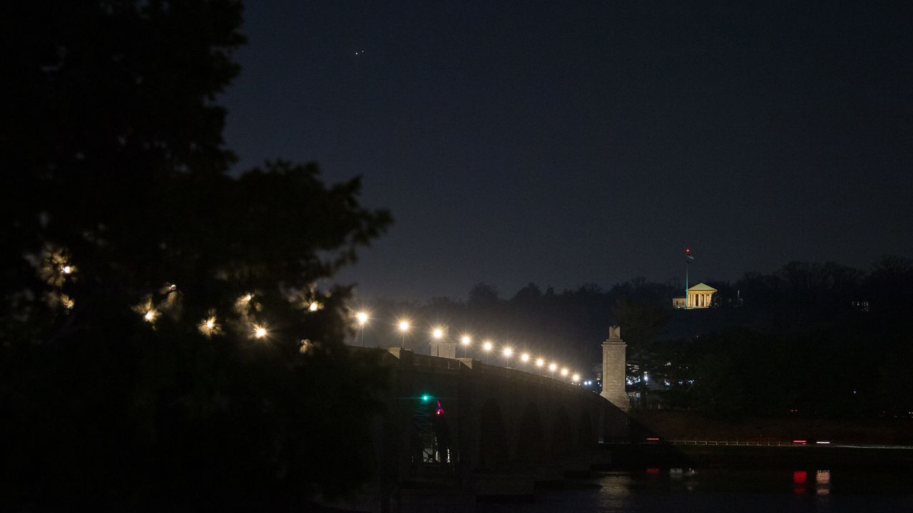 Jupiter (left) and Saturn (right) are seen after sunset above Jordan Lake during the "great conjunction" on Dec. 21, 2020, in Washington, D.C.