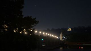 Jupiter (left) and Saturn (right) are seen after sunset above Jordan Lake during the "great conjunction" on Dec. 21, 2020, in Washington, D.C.