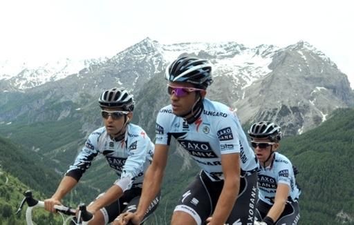 Contador framed by the snow-capped peaks of the Alps
