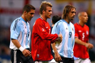 England captain David Beckham leaves the pitch at half-time of the 2002 World Cup group match against Argentina, alongside Diego Simeone and Gabriel Batistuta of Argentina, having given England the lead with a penalty