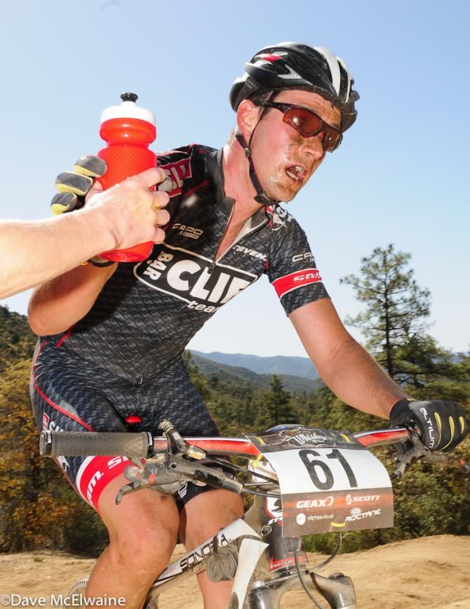 Troy Wells (Cliff Bar) receiving a bottle at the top of the first climb