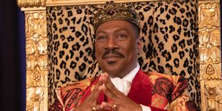 Prince Akeem (Eddie Murphy) smiles as he sits on his throne in Coming 2 America (2021)