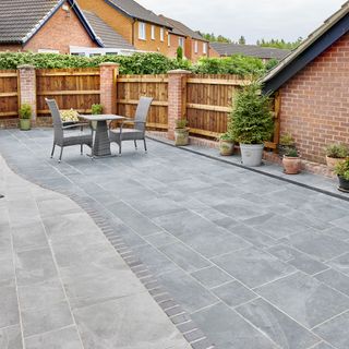 Two tone grey patio area with table and chairs