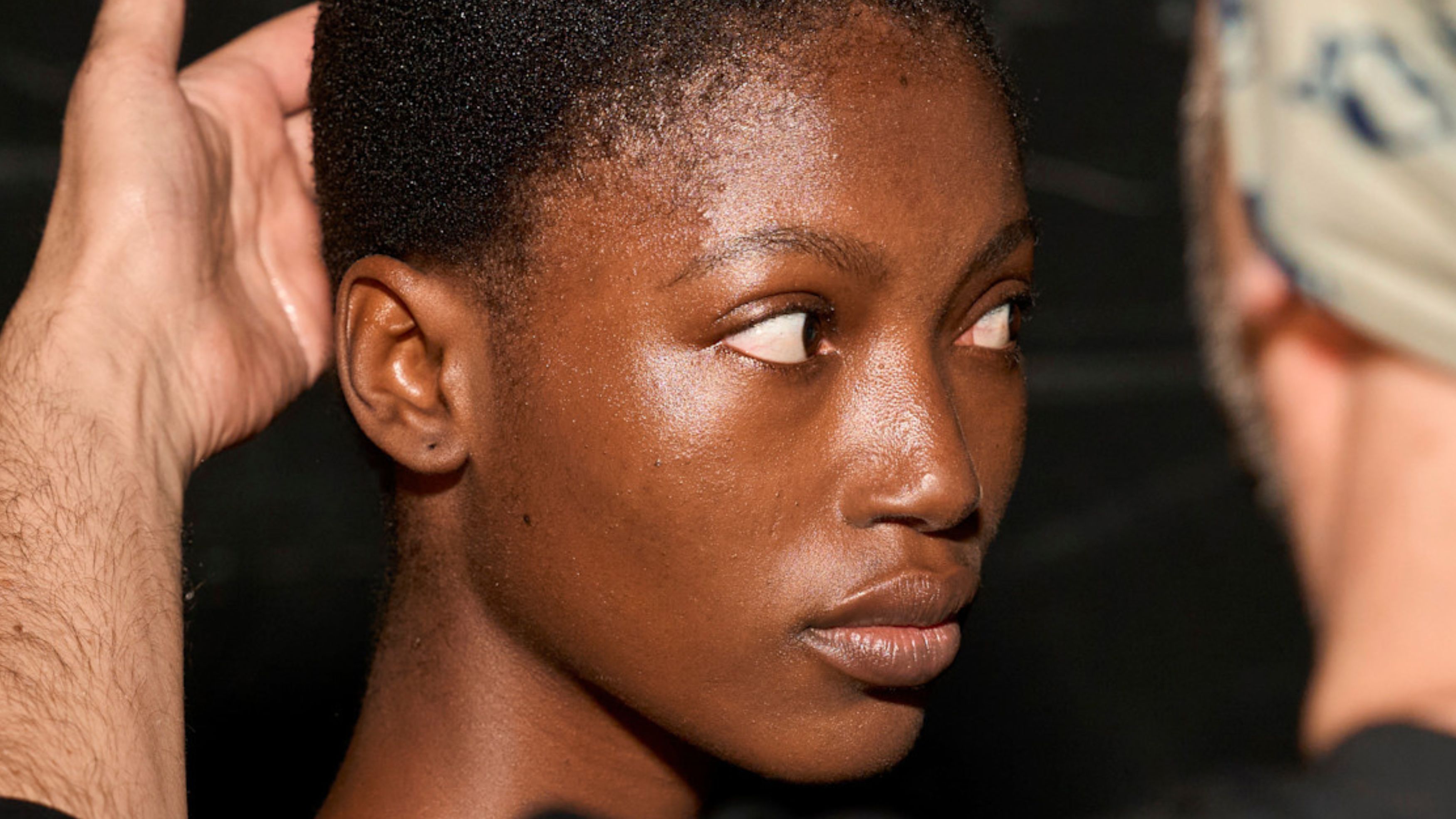 model backstage with glowy skin