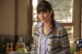 Caroline Catz as Louisa in Doc Martin wearing a cardigan and blue shirt 