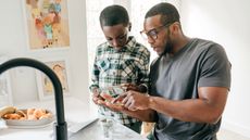 Dad teaching his son about money in the kitchen