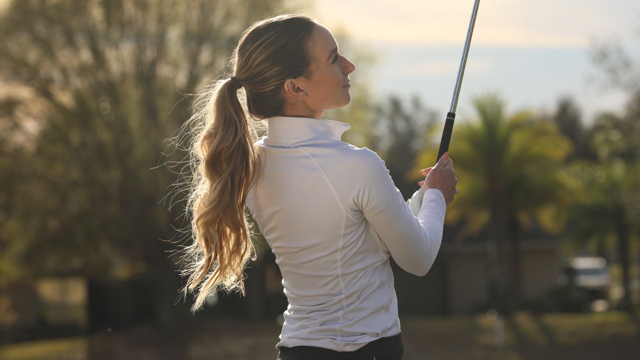 Hannah Gregg looks on after hitting an iron shot