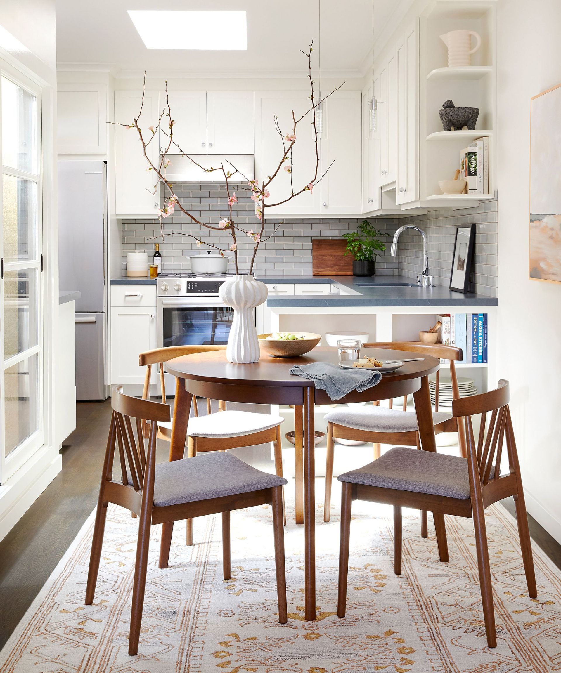 Dining room decorated with a rug featuring spring colors under the dining table