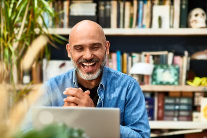 man laughing and smiling on video conference