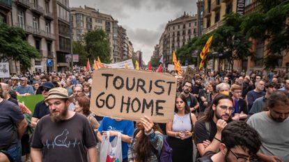  An anti-tourism placard saying 'Tourists go home', at the centre of a demonstration in Barcelona, Spain, June 2024