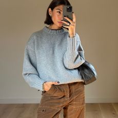 woman in gray sweater and brown pants