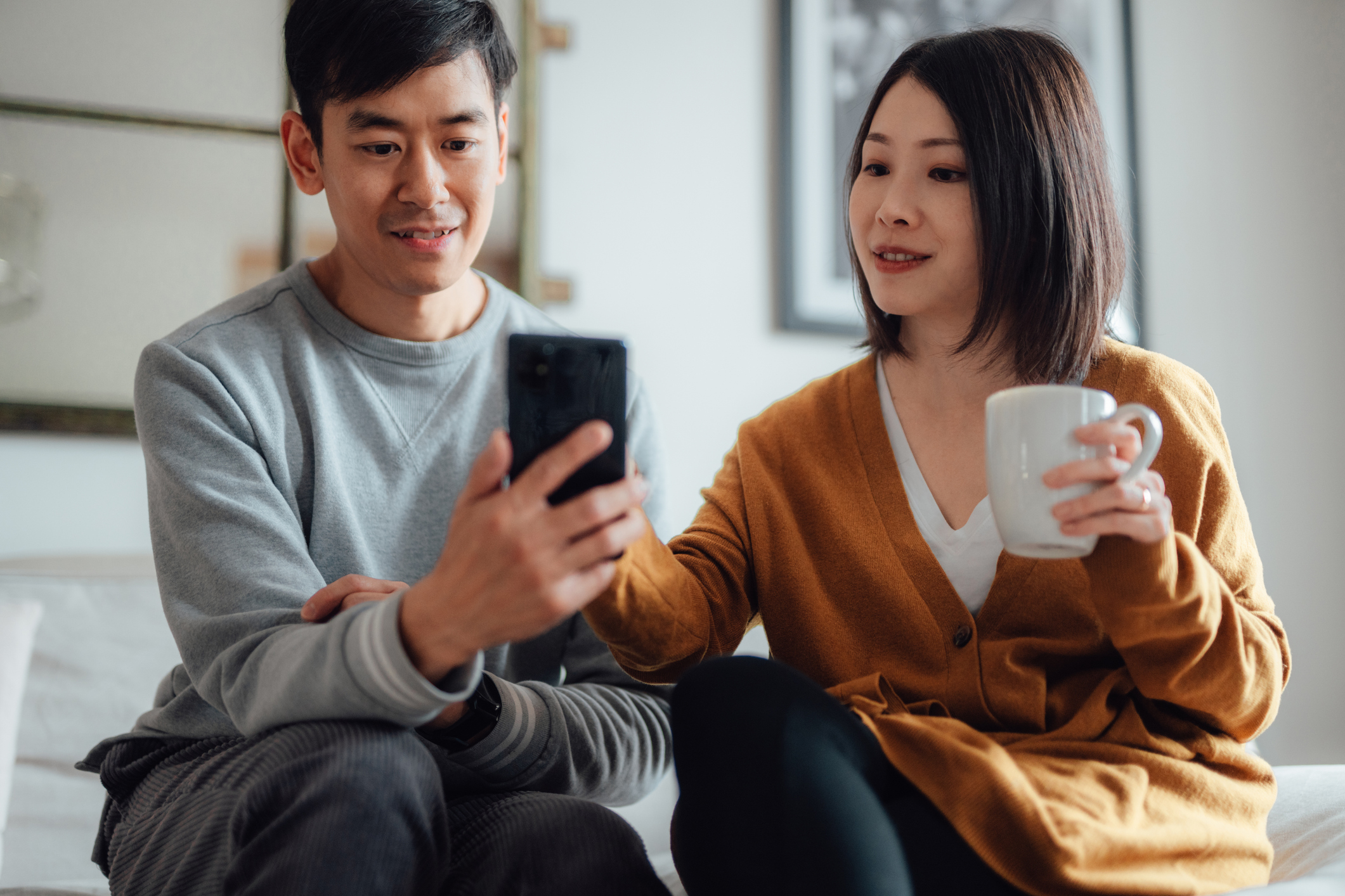 a couple budgeting on a smartphone