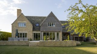 The rear exterior of an oak frame self build with timber and brick cladding