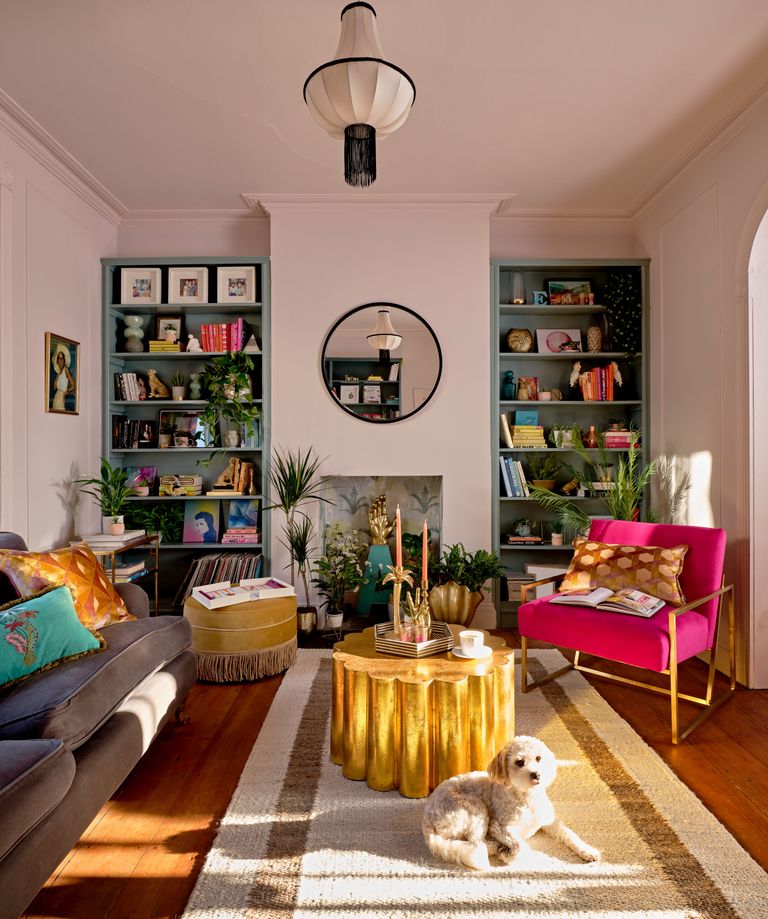 Colorful living room with pink painted walls and the same shade on the ceiling to match 