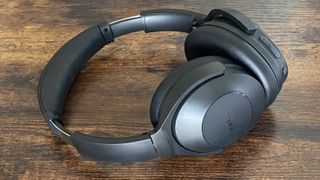 Earfun Wave Life over-ear noise-cancelling headphones on a wooden surface