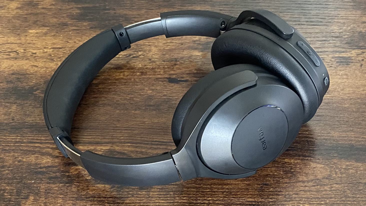 Earfun Wave Life over-ear noise-cancelling headphones on a wooden surface