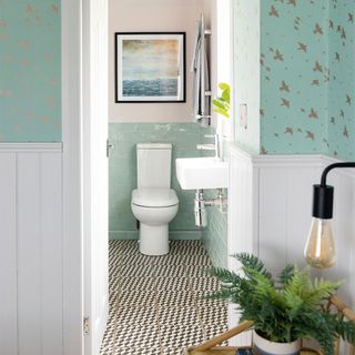 en suite bathroom with green and pink painted walls and tiled floor