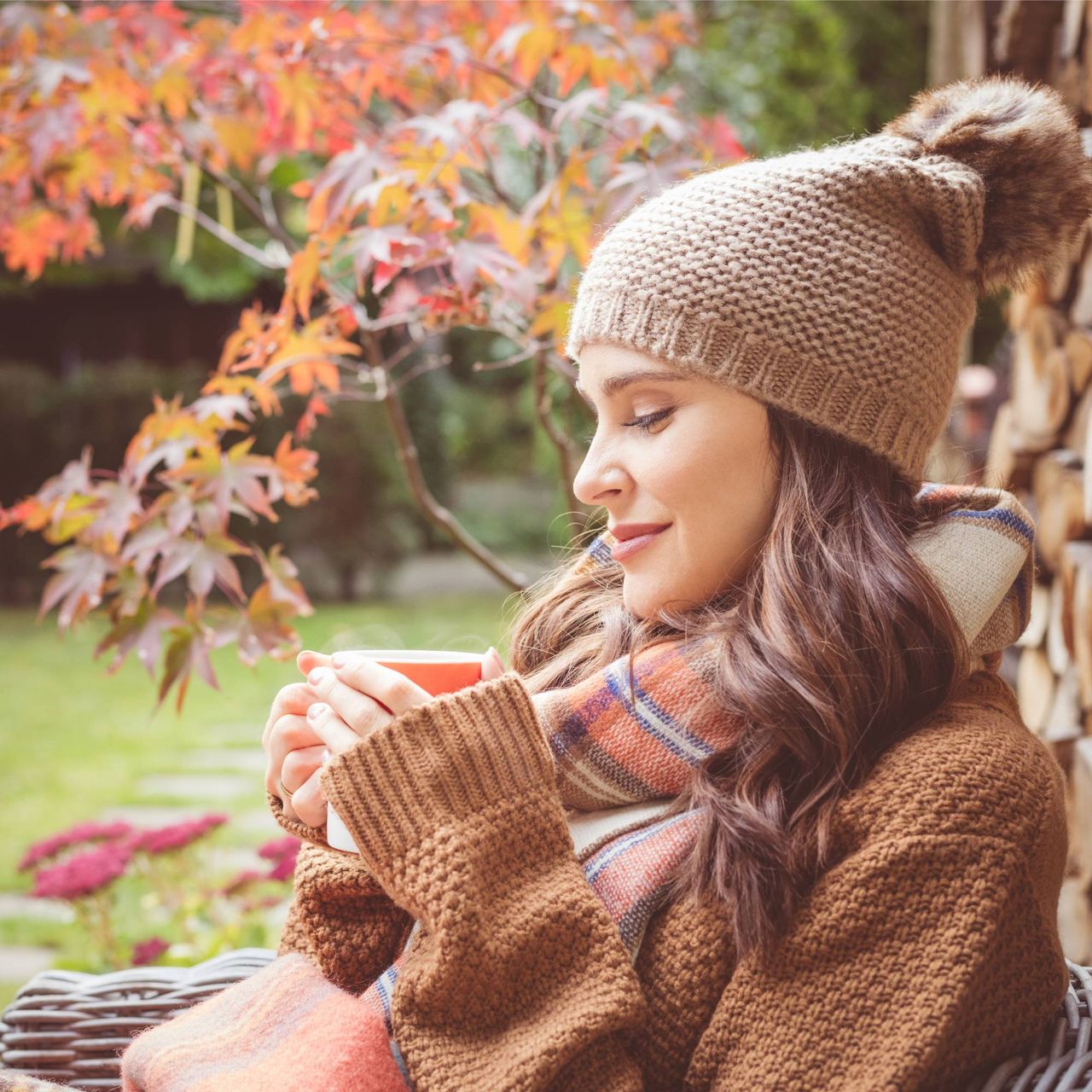 Woman relaxing in fall garden
