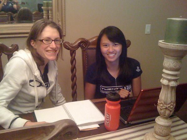 Mara Abbott helps teammate Coryn Rivera with economics homework.