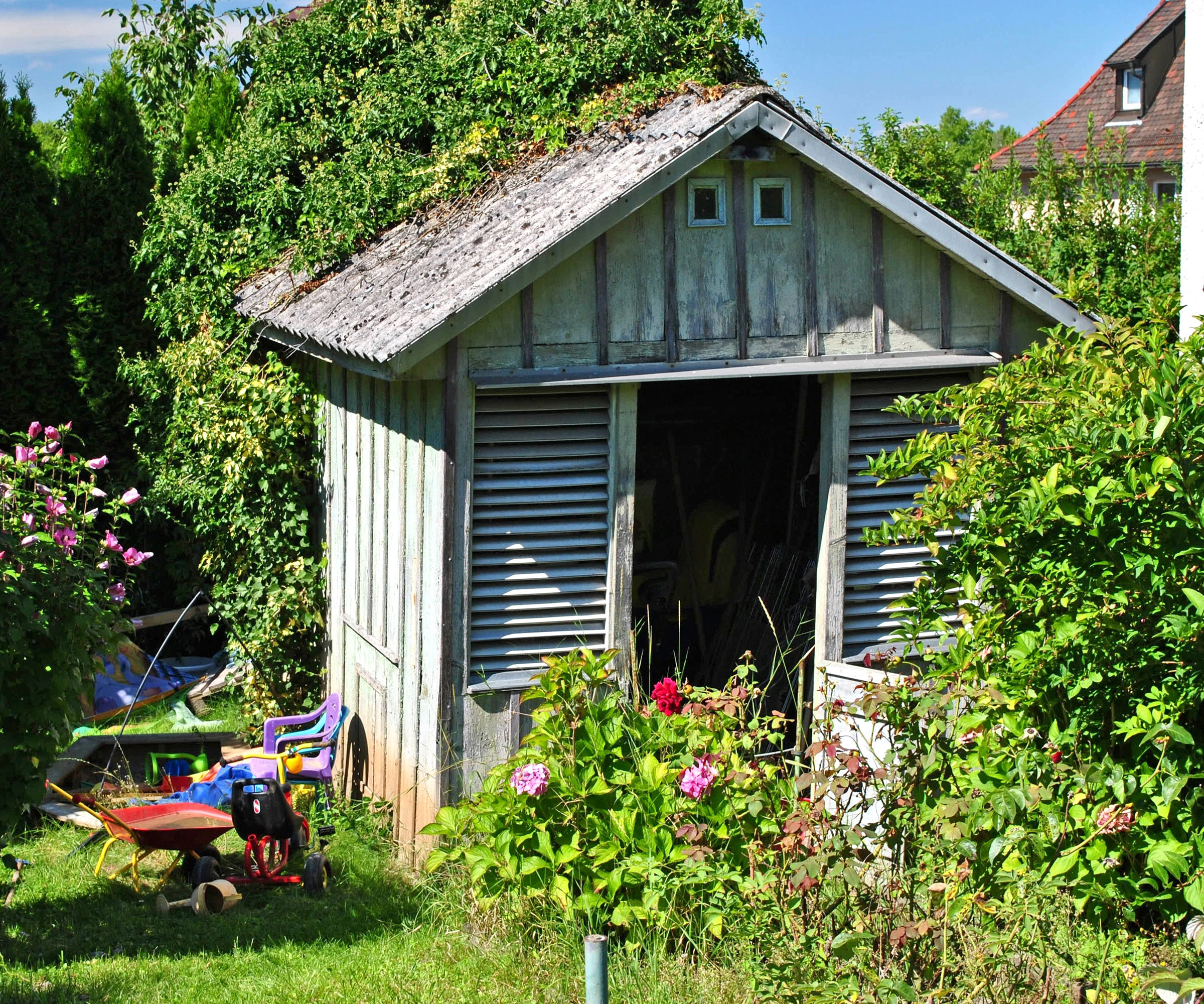 wooden shed on slope in garden