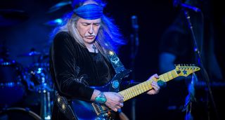 Uli Jon Roth wears a blue bandana as he plays a G3 date in 2018 with his Sky guitar.