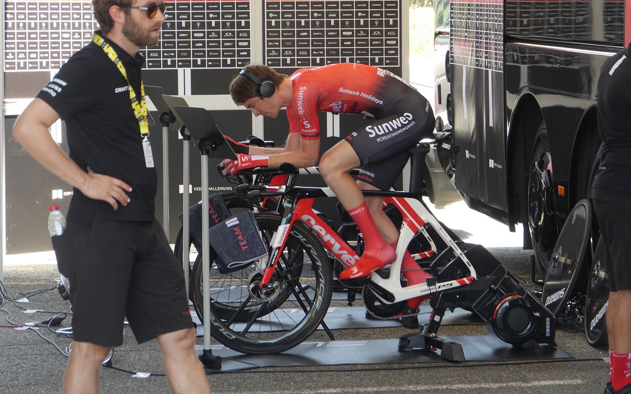 Team Sunweb's Chad Haga warms up in the shade ahead of his effort