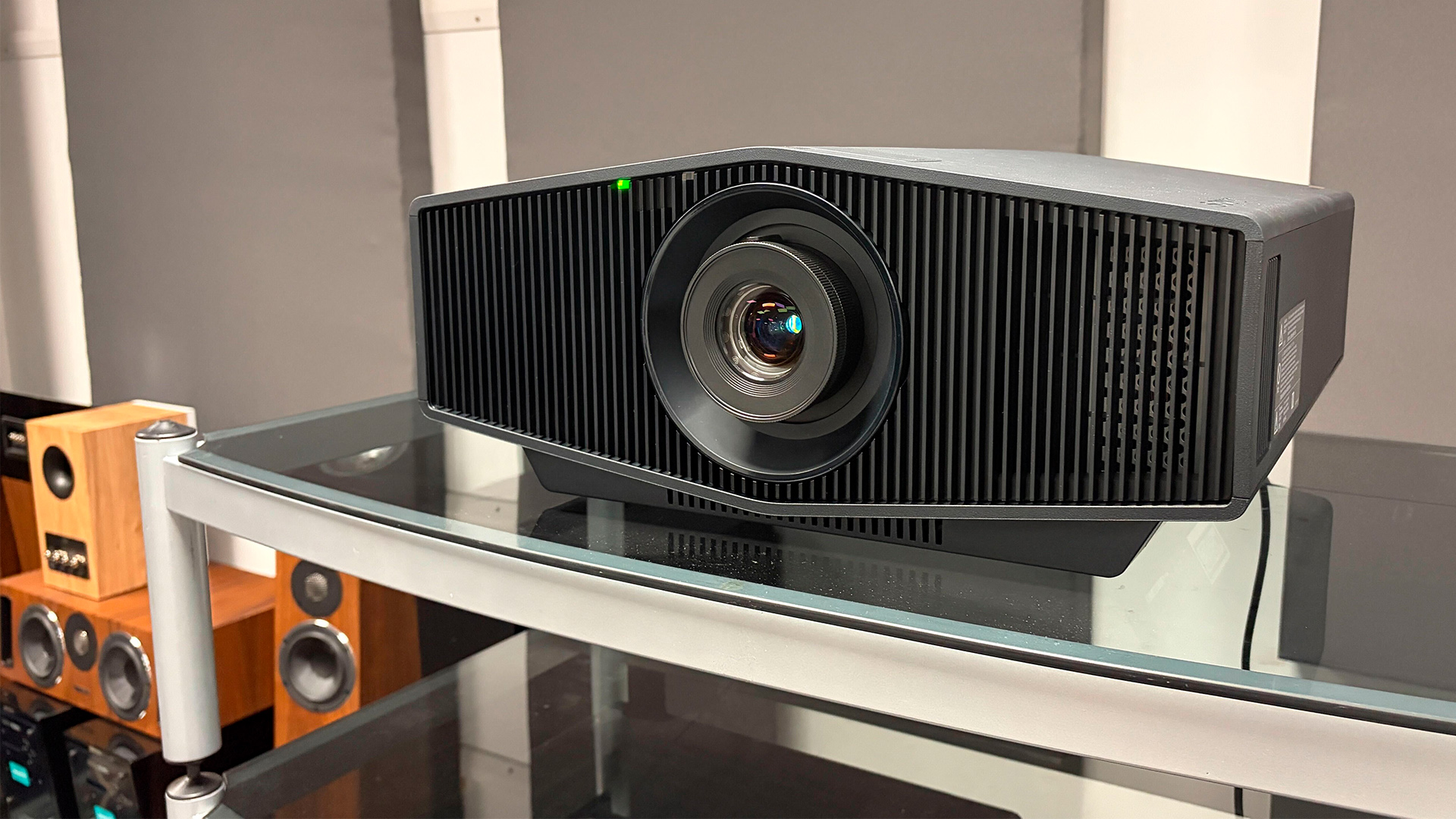 Sony Bravia Projector 7 home cinema projector on glass AV rack, speaker package sitting to left of rack