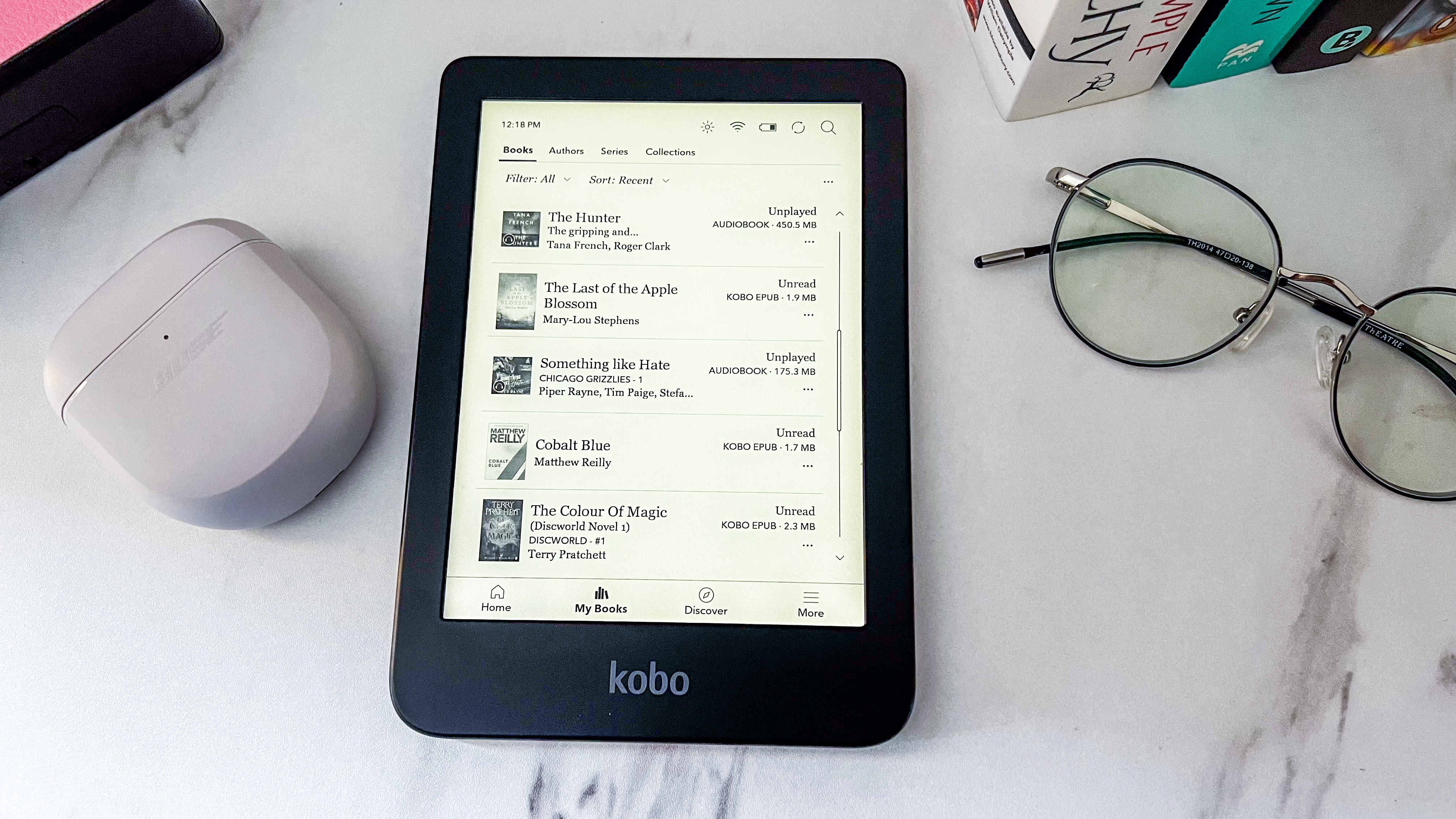 The My Books tab on the Kobo Clara BW displaying a library of ebooks and audiobooks