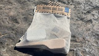 Mesh bag with bike soap and brush inside