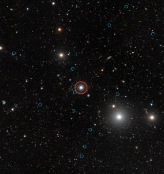 This image from the European Southern Observatory shows so called "dark galaxies" in blue circles around a bright quasar (red circle).